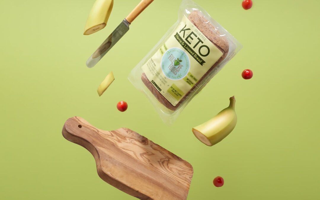 keto bread wooden chopping board with knife and fork sliced banana and cherry tomatoes